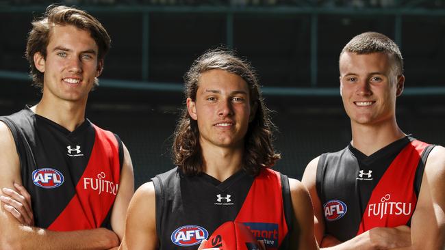 MELBOURNE, AUSTRALIA - DECEMBER 10: Zach Reid, draft selection #10 for the Bombers (L), Archie Perkins, draft selection #9 for the Bombers and Nik Cox, draft selection #8 for the Bombers (R) pose for a photo during the NAB AFL Draft media opportunity at Marvel Stadium on December 10, 2020 in Melbourne, Australia. (Photo by Dylan Burns/AFL Photos via Getty Images)