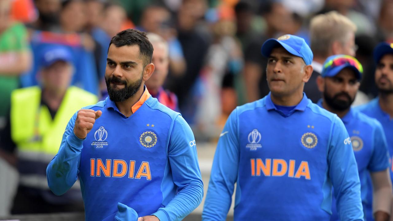 India's captain Virat Kohli (L) is fired up for the first World Cup semi-final. (Photo by Dibyangshu Sarkar / AFP)