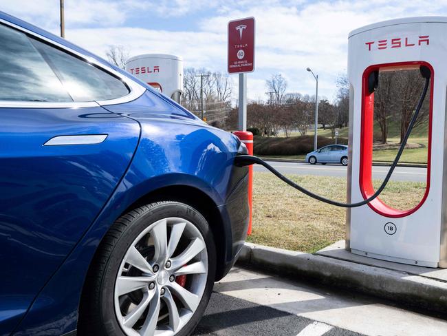 (FILES) A Tesla Model S sedan is plugged into a Tesla Supercharger electrical vehicle charging station in Falls Church, Virginia, February 13, 2023. Tesla reported an 8.5 percent drop in first-quarter auto deliveries on April 2, 2024, missing estimates from leading analysts and weighing on shares. Elon Musk's auto giant reported 386,810 deliveries over the period, reflecting in part a weak market in China, where it faces heavy competition from local electric vehicle makers. Shares fell 5.8 percent in early trading. (Photo by SAUL LOEB / AFP)