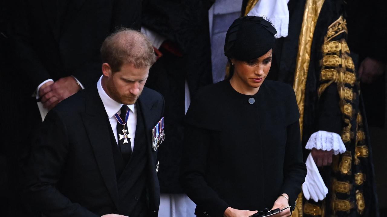 Harry and Meghan bow as they leave the service (Photo by Ben Stansall / POOL / AFP)