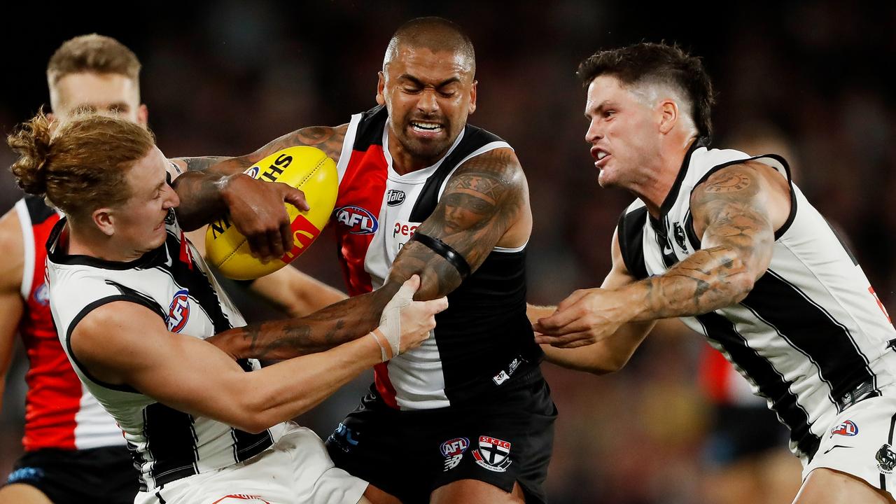 MELBOURNE, AUSTRALIA - MARCH 18: Bradley Hill of the Saints is tackled by Beau McCreery and Jack Crisp of the Magpies during the 2022 AFL Round 01 match between the St Kilda Saints and the Collingwood Magpies at Marvel Stadium on March 18, 2022 In Melbourne, Australia. (Photo by Dylan Burns/AFL Photos via Getty Images)