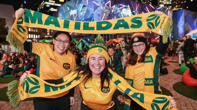 Fans Anna Nguyen, Ash Fraraccio and Elissa Coatat at Federation Square in Melbourne before the quarterfinal match. Picture: Ian Currie