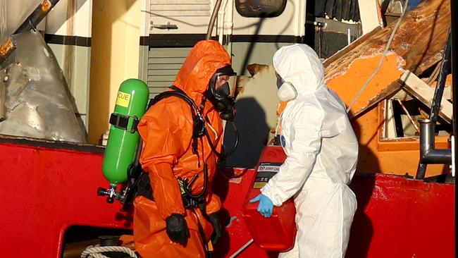 Police and Fire and Rescue NSW personnel in hazmat gear search the fishing trawler 'Coralynne'. Picture: Toby Zerna