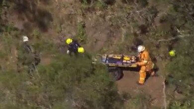 Emergency crews help a hiker after a fall at a popular hinterland walking track. Picture: 7 News Gold Coast