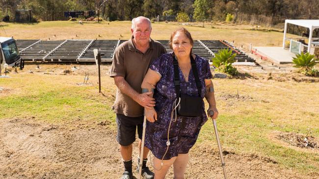 John and Cathy Fawbert pictured in front of their unfinished home in Yowrie. Picture: Ben Marden