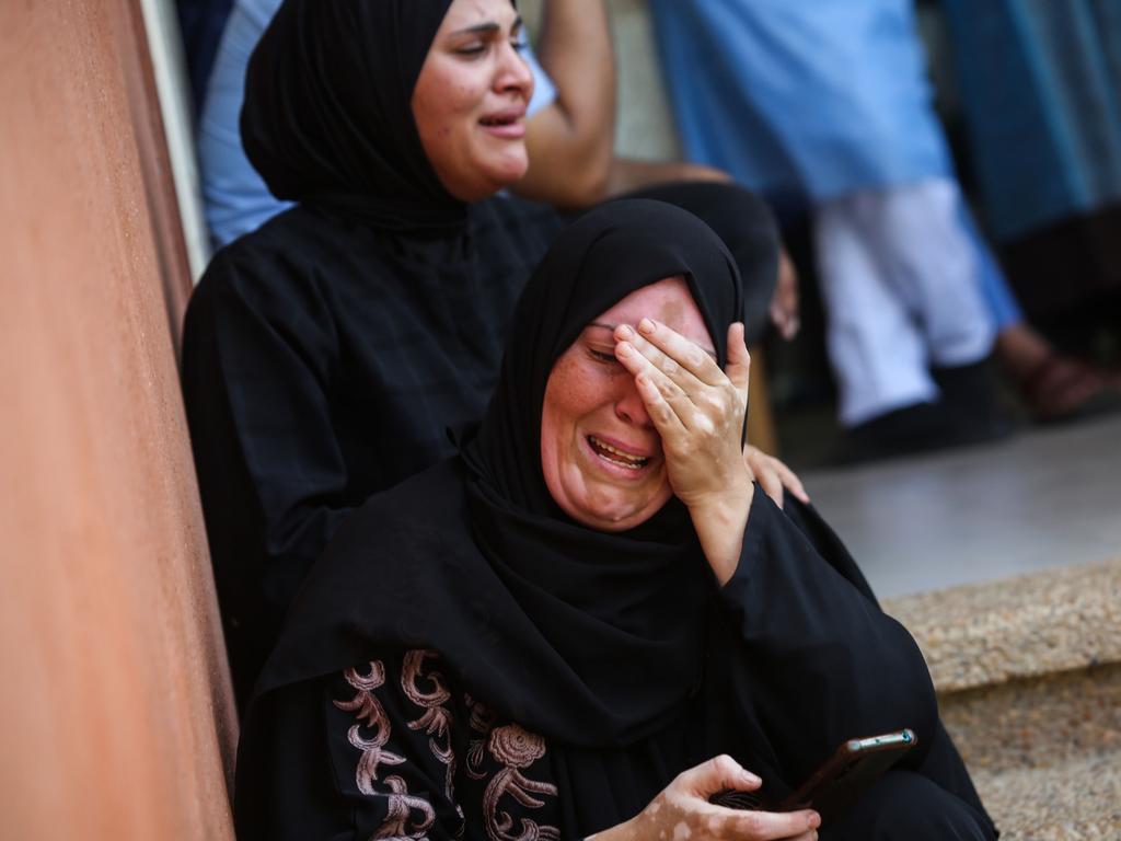 A woman cries as she bids farewell to the bodies of Palestinians killed during Israeli air strikes. (Photo by Ahmad Hasaballah/Getty Images)