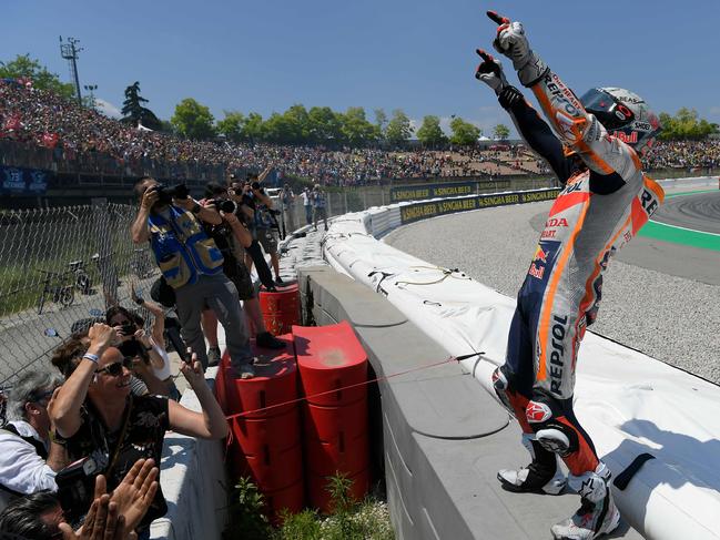 Marc Marquez celebrates with the huge crowd at the Montmelo circuit.