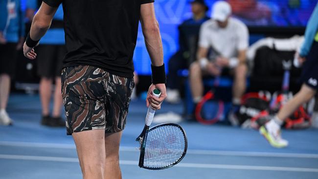 Kokkinakis carries his racquet after breaking it. Picture: William West / AFP