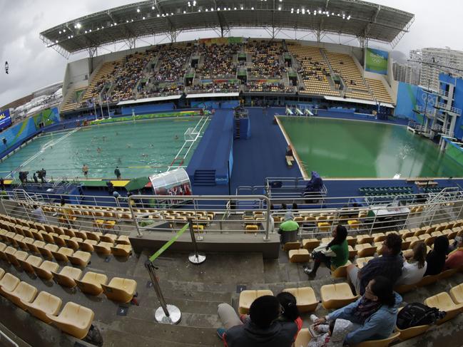 In this picture taken with a fish-eye lens, the water of the diving pool at right appears a murky green as a men's water polo preliminary round match between Greece and Hungary takes place at left in the Maria Lenk Aquatic Center at the 2016 Summer Olympics in Rio de Janeiro, Brazil, Wednesday, Aug. 10, 2016. (AP Photo/Matt Dunham)