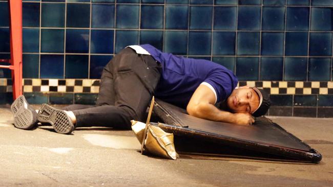 Montoya succumbs to the comforts of the kerb after partying hard at The Rocks. Picture: Christian Gilles