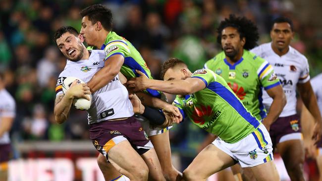 Broncos forward Matt Gillett is wrapped up by the Raiders defence.