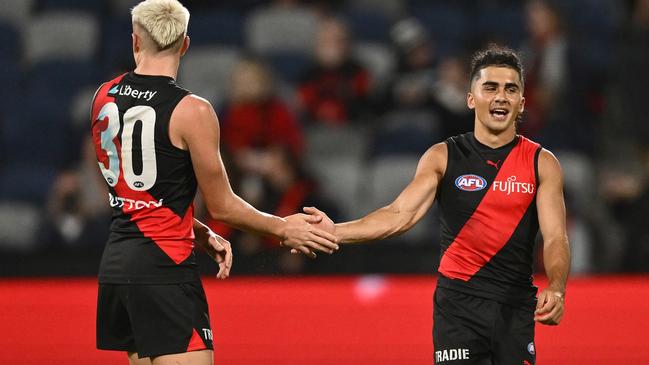 Nate Caddy (left) and Isaac Kako celebrate the victory over Geelong. (Photo by Quinn Rooney/Getty Images)