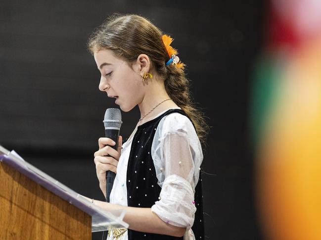 Ramona Hamad tells her story as an Iraqi Yazidi to the school assembly during Harmony Day celebrations at Darling Heights State School, Wednesday. Picture: Kevin Farmer