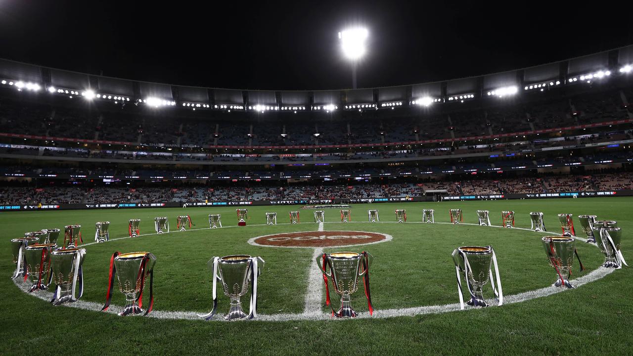 All of Essendon’s and Carlton’s premiership cup in the centre circle before their round 13 game. Photo: Michael Klein.