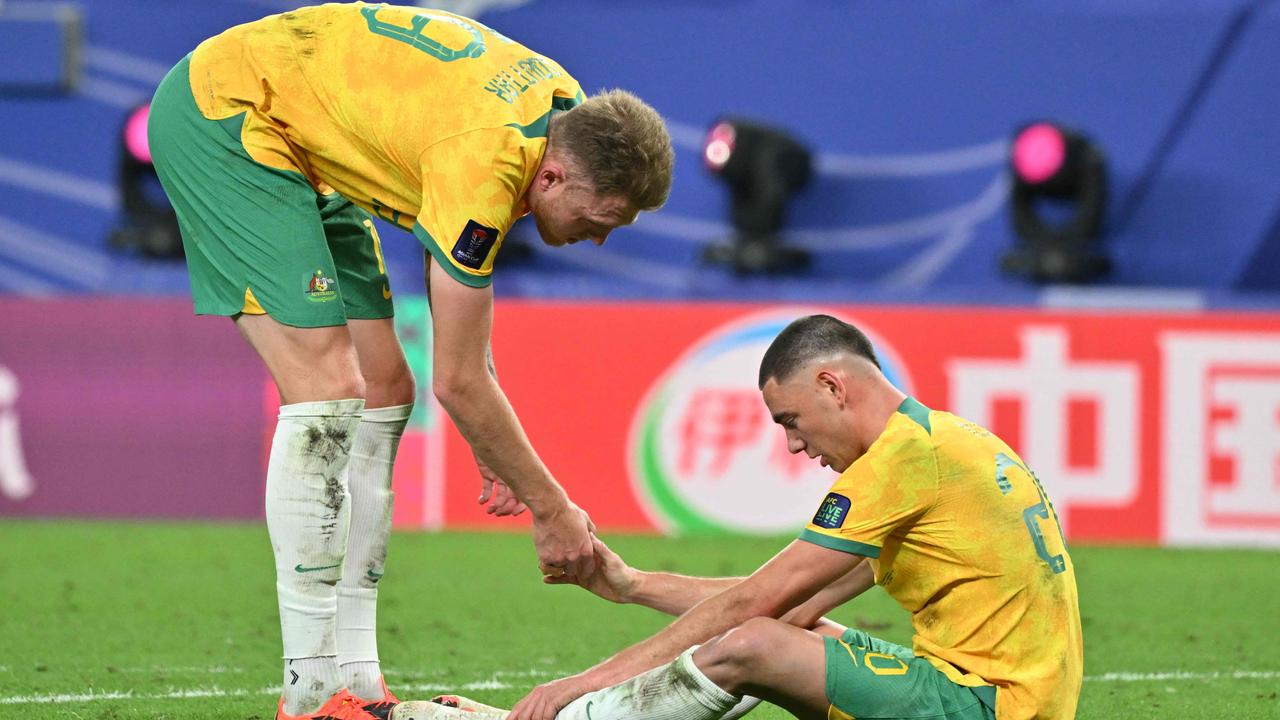 Australia's defender #19 Harry Souttar consoles Australia's defender #20 Lewis Miller after their defeat. (Photo by HECTOR RETAMAL / AFP)