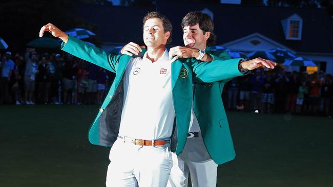 Adam Scott receives his green jacket from 2012 Masters champion Bubba Watson. Picture: AFP