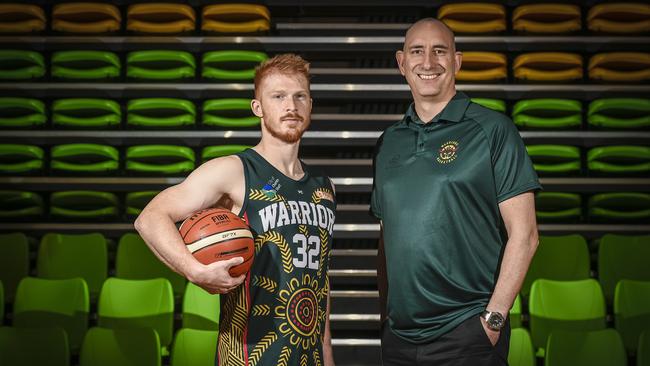 Woodville player James Boonstoppel and coach Scott Whitmore pictured last year with the club’s National Reconcilliation Week uniforms. Whitmore believes the Warriors are on the up in 2020. Picture: AAP/Roy VanDerVegt