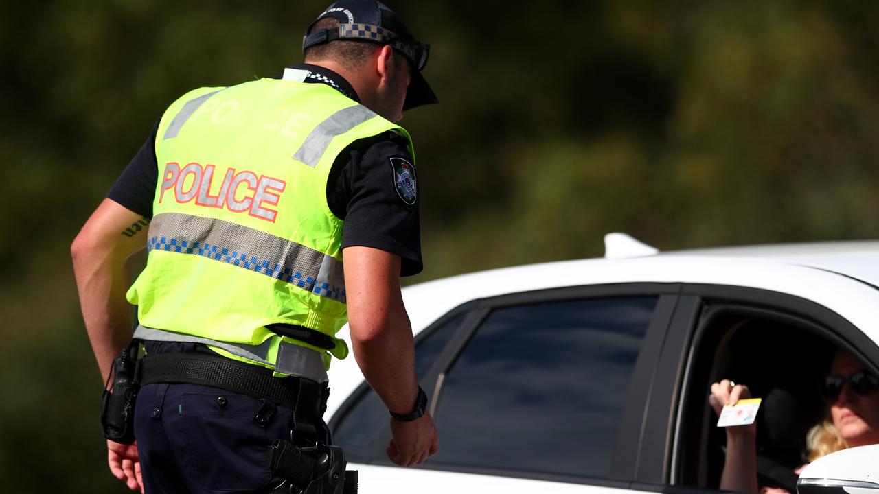 Queensland Police check a car at the border.