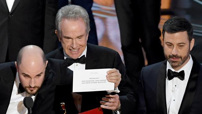 HOLLYWOOD, CA - FEBRUARY 26:  (L-R) 'La La Land' producer Jordan Horowitz holds up the winner card reading actual Best Picture winner 'Moonlight' with actor Warren Beatty and host Jimmy Kimmel onstage during the 89th Annual Academy Awards at Hollywood & Highland Center on February 26, 2017 in Hollywood, California.  (Photo by Kevin Winter/Getty Images)