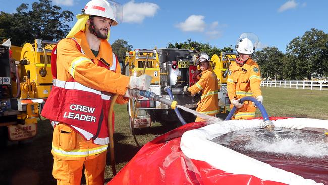 Rural firies crew leader Jordan Sugar with Matt Canafe and Adrianna Tkac take part in the third annual Gold Coast Group Exercise hosted by the Gold Coast Rural Fire Brigade Group. Picture: Richard Gosling.