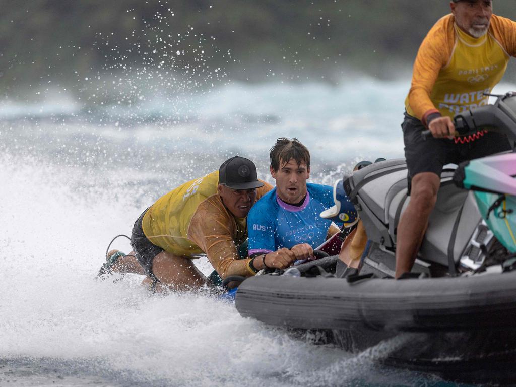 Jack Robinson of Team Australia is rescued by water patrol after falling during round three of surfing on day three of the Olympic Games in Teahupo'o, French Polynesia. Picture: Ed Sloane / POOL / AFP.