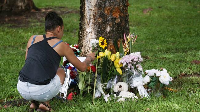 Denise Weazael of Manoora lays some flowers at the scene of the crash last year. Picture: Brendan Radke