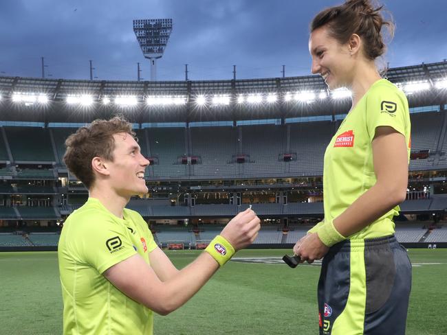 AFL umpire Dillon Lee asks ALF first field umpire Eleni Glouftsis to marry him after the Round 19 AFL match between the Carlton Blues and the Adelaide Crows at the MCG in Melbourne, Saturday, July 27, 2019. (AAP Image/David Crosling) NO ARCHIVING, EDITORIAL USE ONLY