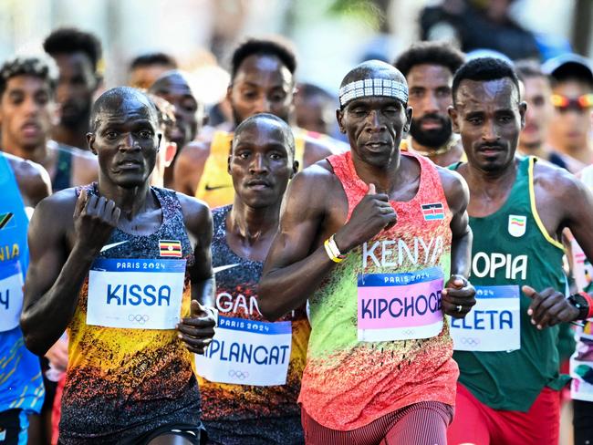 Kenya's Eluid Kipchoge and other athletes compete in the men's marathon of the athletics event at the Paris 2024 Olympic Games in Paris on August 10, 2024. (Photo by Kirill KUDRYAVTSEV / AFP)