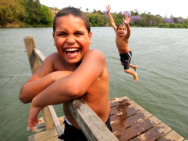 Tyrell Walker, 8, with Anton Atkinson, 8, from Bellbrook cooling of in the Macleay River.