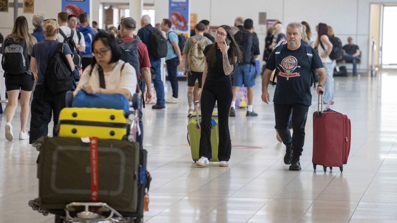 Travellers move through Adelaide Airport in April. Police are investigating reports of thieves targeting the baggage reclaim area of the airport and making off with luggage. Picture: NewsWire / Kelly Barnes