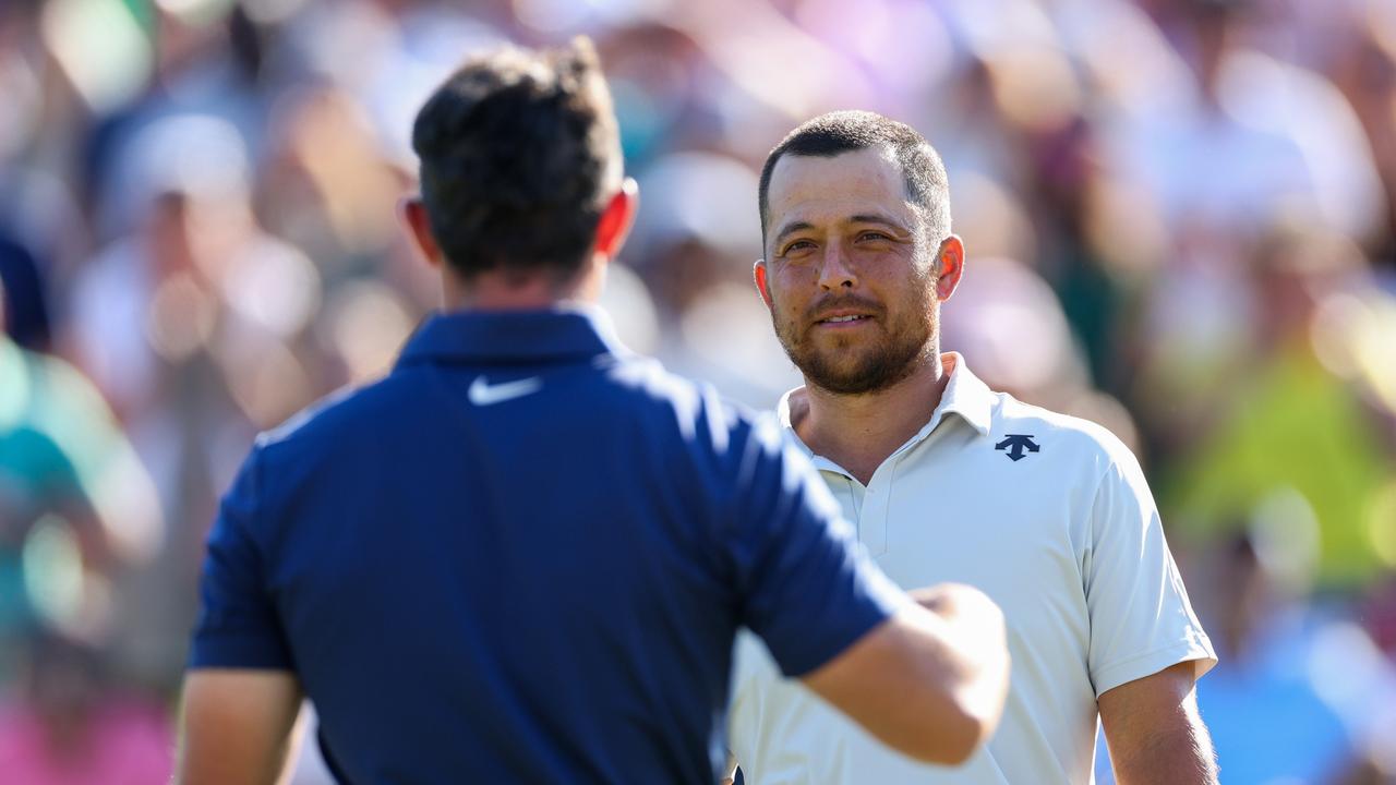 Xander Schauffele shakes hands with Rory McIlroy of Northern Ireland after they finished the third round of the Wells Fargo Championship at Quail Hollow Country Club on May 11, 2024 in Charlotte, North Carolina. (Photo by Andrew Redington/Getty Images)