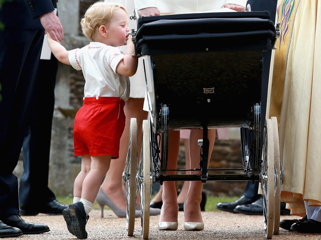 Pringe George takes a peek into Princess Charlotte’s pram ahead of her Christening in July 2015. Picture: Chris Jackson/Getty Images