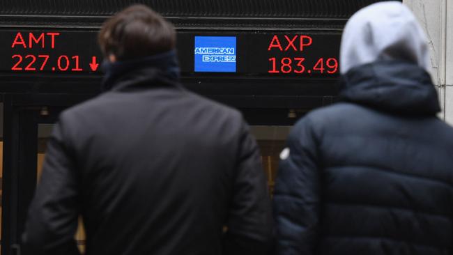 People watch monitors outside the New York Stock Exchange on Wall Street last week. Picture: AFP