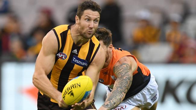 Hawks defender James Frawley looks to handball. Picture: Julian Smith