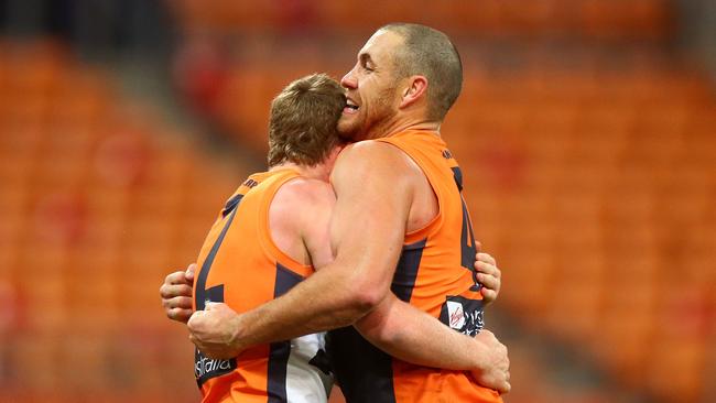 Tom Green and Shane Mumford embrace after GWS’ win on Friday.