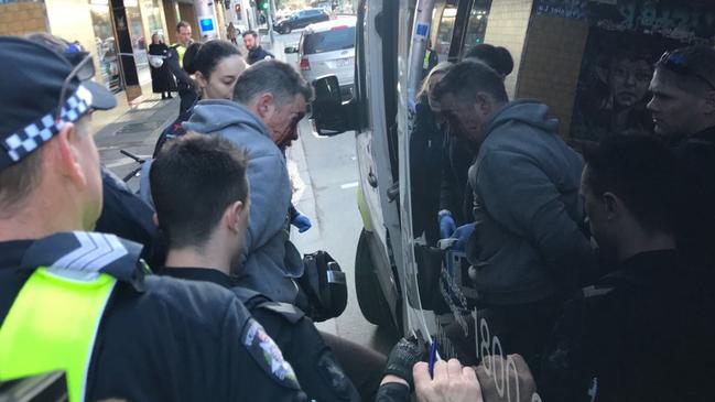 Mr Dick being treated by paramedics near Hosier Lane. Picture: Twitter/@Cameron Baud