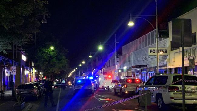 Police and ambulance crews at the scene of a serious stabbing on Hindley St on Friday night. The street was closed between Morphett St and West Tce, with detectives on-site. Picture: George Yankovich