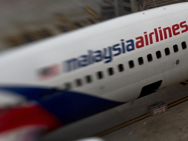 (FILES) This file photo taken with a tilt and shift lens on June 16, 2014 shows a Malaysia Airlines plane parked on the tarmac at Kuala Lumpur International Airport in Sepang. The official search for MH370 may have been called off but experts believe the missing airliner will one day be found, perhaps either by deep-sea miners or treasure hunters lured by a huge cash reward. After spending almost three years and 150 million USD on a deep sea hunt for the Malaysian passenger jet in the remote Indian Ocean off western Australia, top aviation investigators have been forced to admit they have come up with nothing.  / AFP PHOTO / MANAN VATSYAYANA / TO GO WITH Australia-Malaysia-China-MH370-aviation,FOCUS by Glenda KWEK