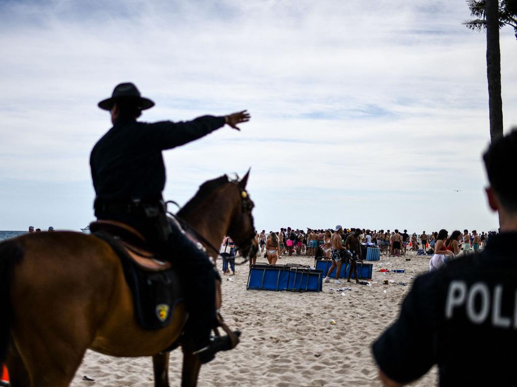Police officers kick partygoers off the beach in Fort Lauderdale, Florida. Picture: Chandan Khanna/AFP