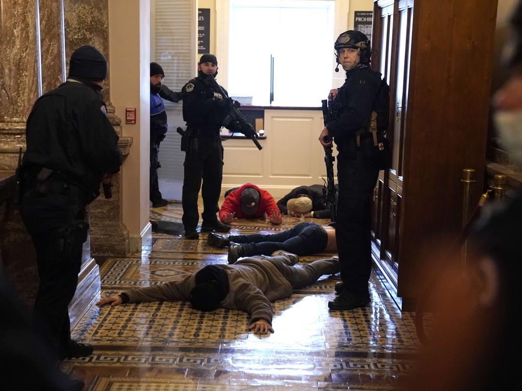 U.S. Capitol Police stand detain protesters outside of the House Chamber during a joint session of Congress. Picture: Getty