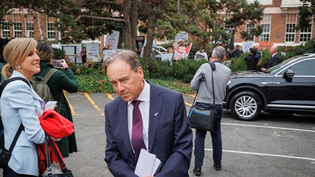 Then health minister Greg Hunt in Tasmania as protesters rally behind him. Picture: Jason Edwards