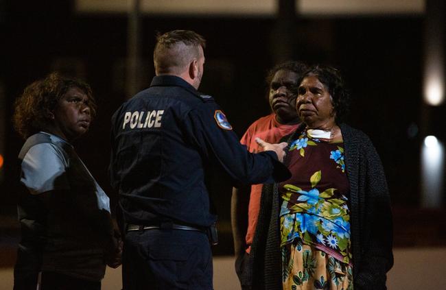 Family members question a police officer at the Alice Springs Hospital, hoping to find out if the man was still alive. Picture: Emma Murray