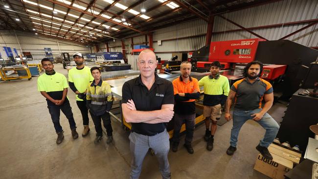 Illusion Gas Log Fires General Manager Nicholas Smith on the factory floor in Dandenong with staff Kanishka, Hashan, Ray, Sohrab, Asanka and Isuru. Picture: Alex Coppel.