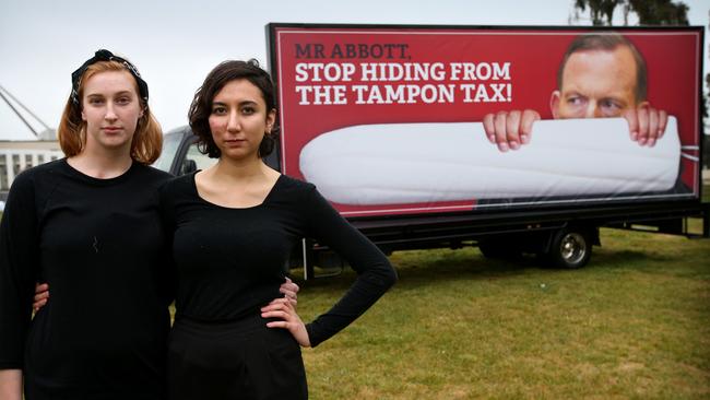 The battle against the tampon tax has been a long one. Georgia Mantle and Ella Bickley from the Woman's Collective at University of Sydney protest outside Parliament House in 2015. (Pic: Kym Smith)