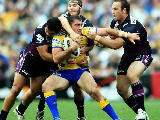Tim Mannah is tackled by Storm - 2009 NRL Grand Final Parramatta Eels v Melbourne Storm - ANZ Stadium, Homebush.