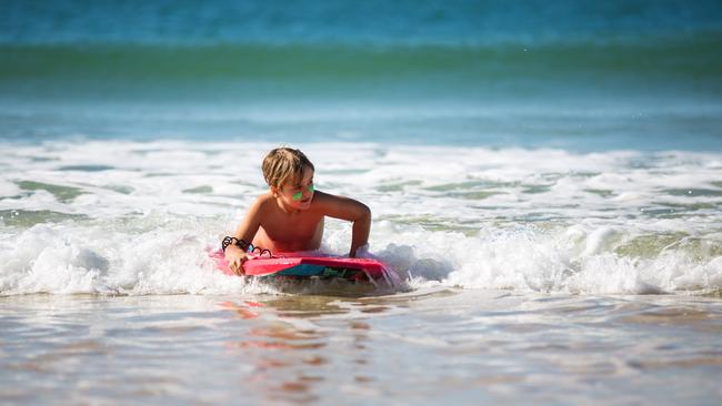 School holiday fun in the Moreton Bay Region: hitting the waves at Woorim, Bribie Island. Photo: Dominika Lis.