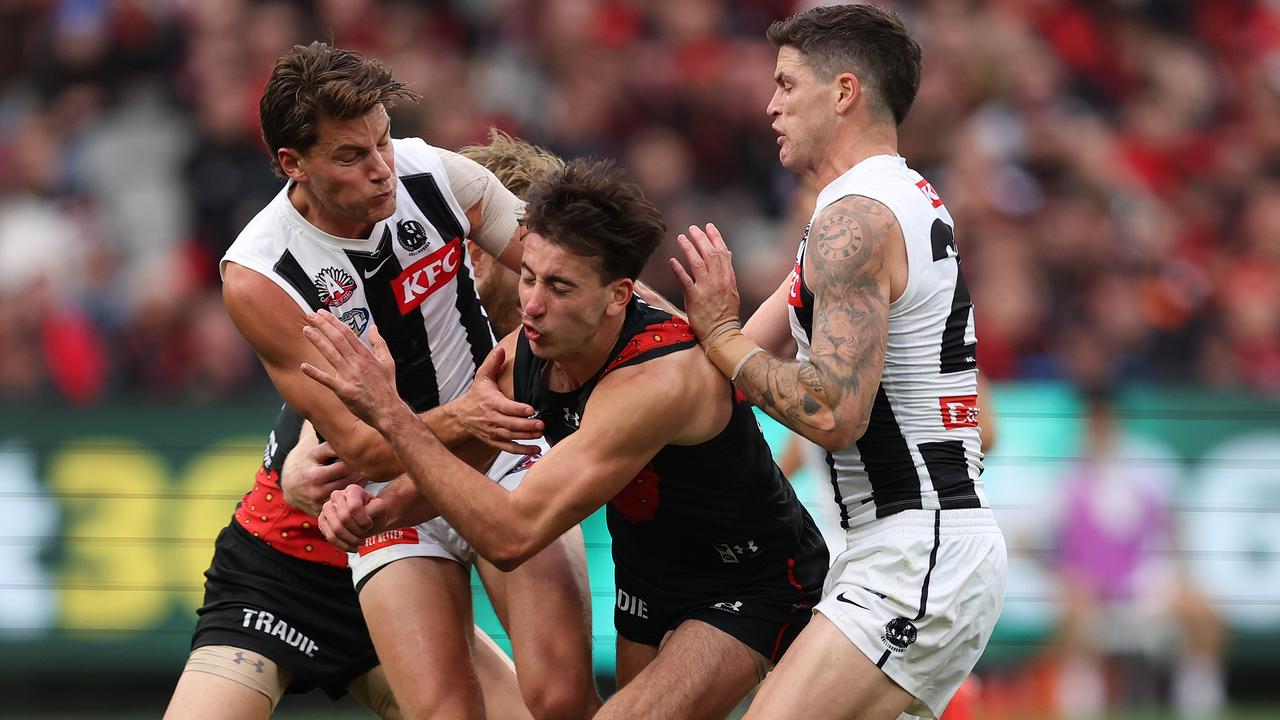 MELBOURNE, AUSTRALIA - APRIL 25: Nic Martin of the Bombers is challenged by Patrick Lipinski and Jack Crisp of the Magpies during the round seven AFL match between Essendon Bombers and Collingwood Magpies at Melbourne Cricket Ground, on April 25, 2024, in Melbourne, Australia. (Photo by Robert Cianflone/Getty Images)