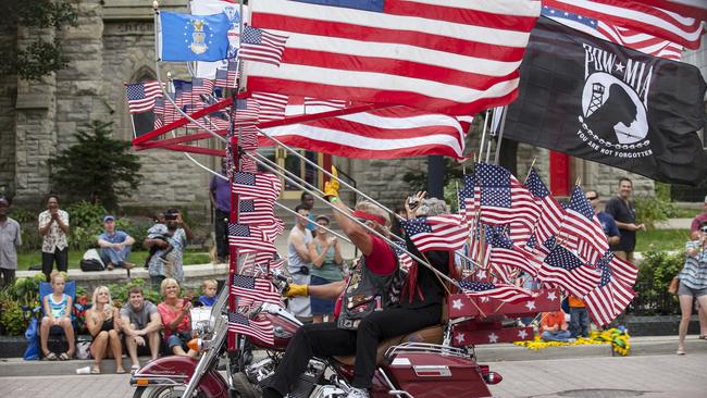 Spectators line the street as Harley riders participate during the the Harley Davidson 110th Anniversary Celebration parade in Wisconsin Avenue, Milwaukee August 31, 2013. Tens of thousands of Harley-Davidson enthusiasts from all corners of the globe make the pilgrimage to Milwaukee for the motorcycle maker's 110th anniversary celebration over the Labor Day weekend. REUTERS/Sara Stathas (UNITED STATES - Tags: SOCIETY ANNIVERSARY) - GM1E99108VK01