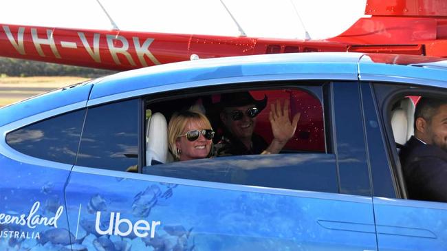 Gladstone couple Terry and Kym Purcell pictured next to the helicopter they took to Heron Island and official scUber Tesla driver Domenico Galluccio. Picture: Matt Harris