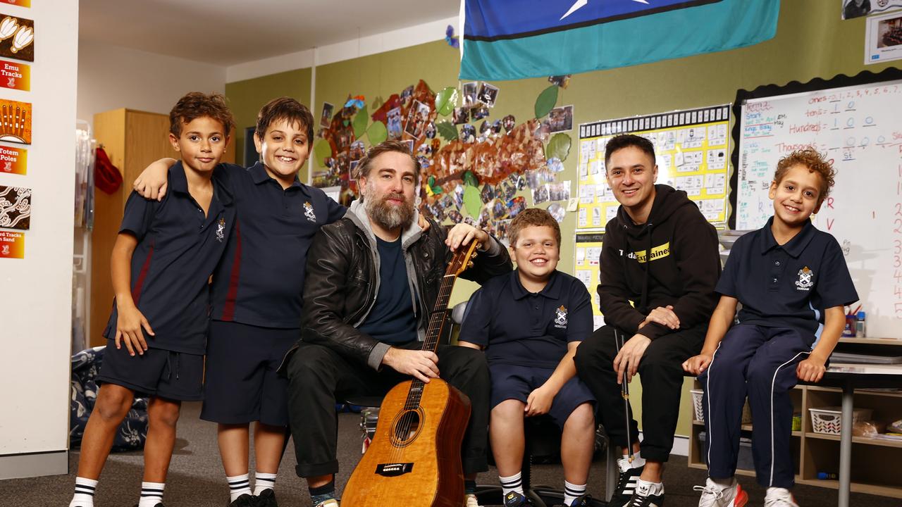 Australian singer-songwriter Josh Pyke and Hip Hop artist Rhyan Clapham (DOBBY) with students from St Andrew’s Cathedral Gawura School in Sydney for last year’s Busking for Change. Picture: Richard Dobson